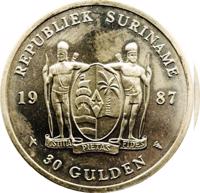 Suriname coin 30 Gulden - 30th Anniversary of the Central Bank (1987) obverse obverse of 30 Gulden - 30th Anniversary of the Central Bank (1987) coin with KM# 27 from Suriname. Inscription: REPUBLIEK SURINAME 19 87 JUSTITIA PIETAS FIDES 30 GULDEN