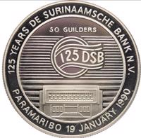 Suriname coin 50 Guilders - 125th Anniversary De Surinaamsche Bank (1990) reverse reverse of 50 Guilders - 125th Anniversary De Surinaamsche Bank (1990) coin with KM# 30 from Suriname. Inscription: 125 YEARS DE SURINAAMSCHE BANK N.V. 50 GUILDERS 125 DSB PARAMARIBO 19 JANUARY 1990