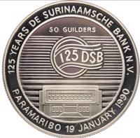 reverse of 50 Guilders - 125th Anniversary De Surinaamsche Bank (1990) coin with KM# 30 from Suriname. Inscription: 125 YEARS DE SURINAAMSCHE BANK N.V. 50 GUILDERS 125 DSB PARAMARIBO 19 JANUARY 1990