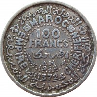 Morocco coin 100 Francs - Mohammed V (1953) reverse reverse of 100 Francs - Mohammed V (1953) coin with Y# 52 from Morocco. Inscription: MAROC EMPIRE CHERIFIEN 100 FRANCS AN 1953 1372 J.HAINAUT